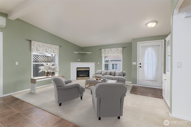 carpeted living area featuring a tile fireplace, vaulted ceiling with beams, baseboards, and tile patterned floors