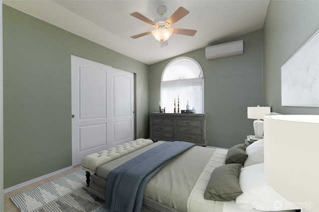 bedroom featuring an AC wall unit, ceiling fan, and baseboards