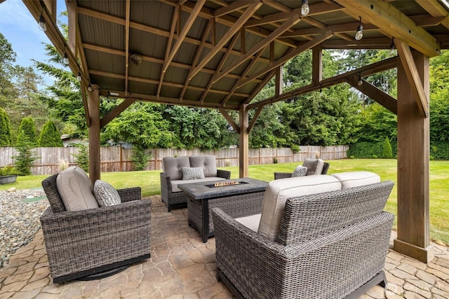 view of patio featuring an outdoor living space with a fire pit, a fenced backyard, and a gazebo