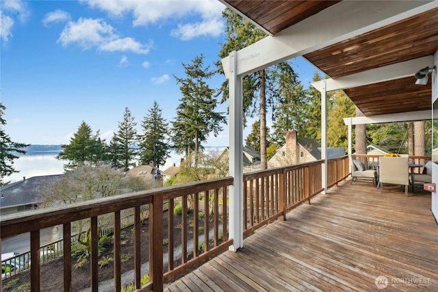 wooden terrace featuring a water view