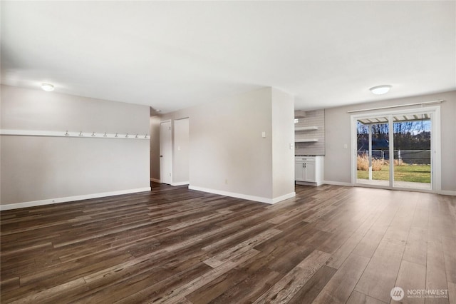 unfurnished living room with dark wood-type flooring