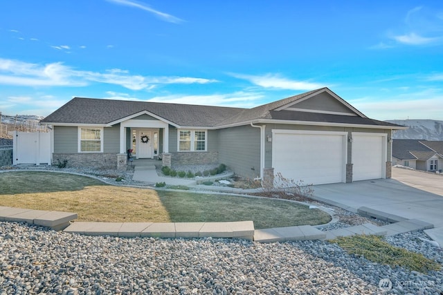 ranch-style house featuring a garage and a front lawn