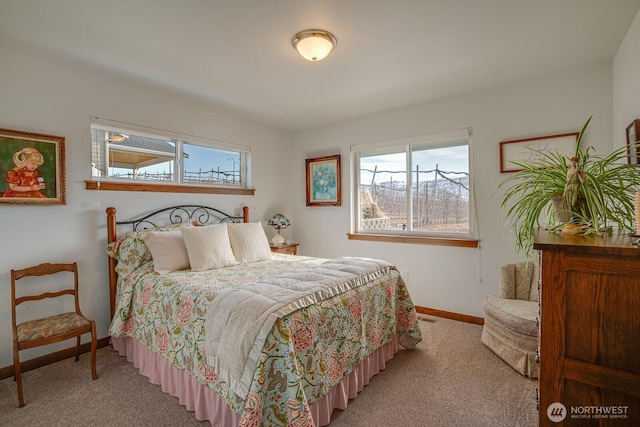 bedroom with light carpet and multiple windows