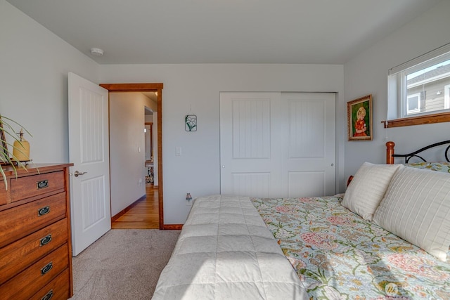 bedroom featuring a closet and light carpet