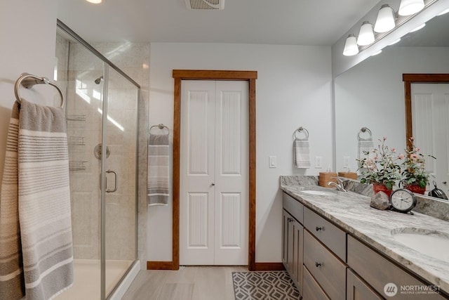 bathroom with vanity and walk in shower