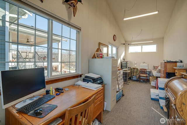 home office with light carpet and lofted ceiling