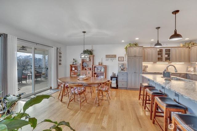 dining area featuring sink and light hardwood / wood-style floors