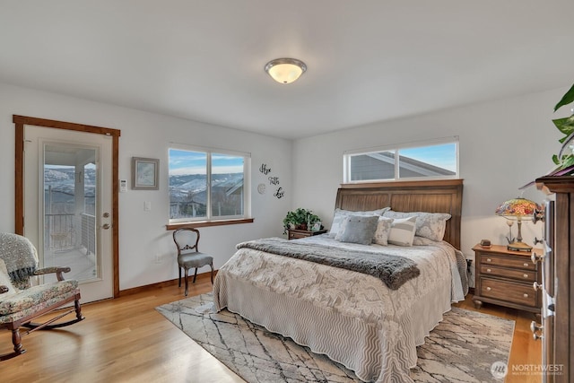 bedroom featuring access to exterior and light hardwood / wood-style floors