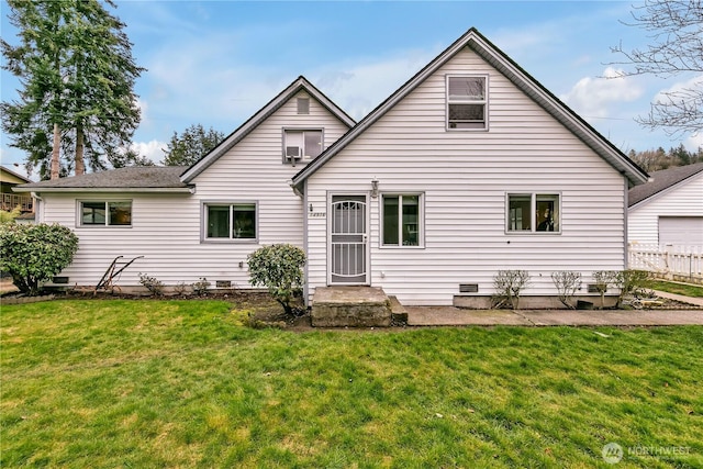 rear view of house featuring crawl space and a lawn