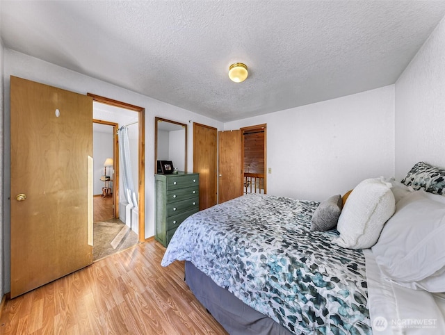 bedroom featuring a textured ceiling and wood finished floors