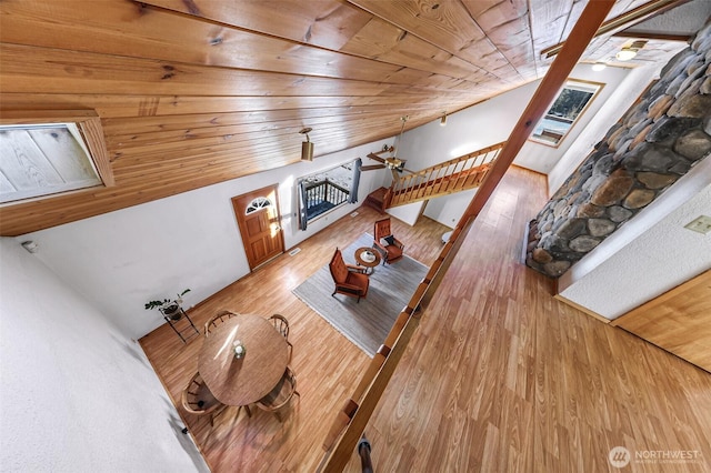 living room featuring stairs, wooden ceiling, lofted ceiling, and light wood-style floors