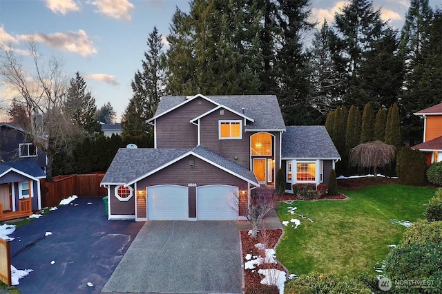 view of property featuring a garage and a yard