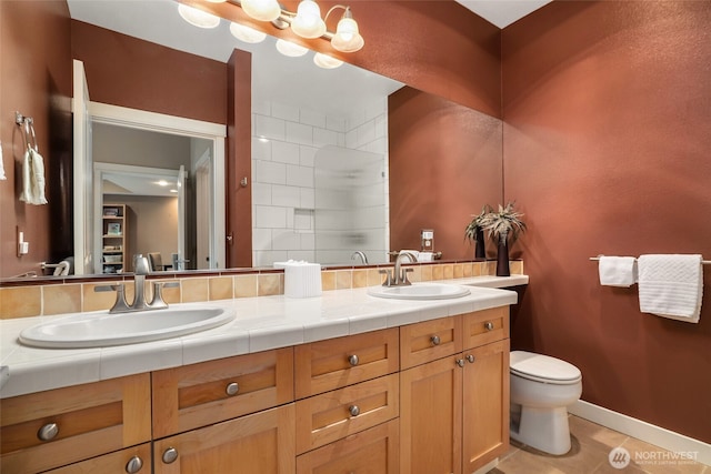 bathroom with walk in shower, vanity, toilet, and tile patterned flooring