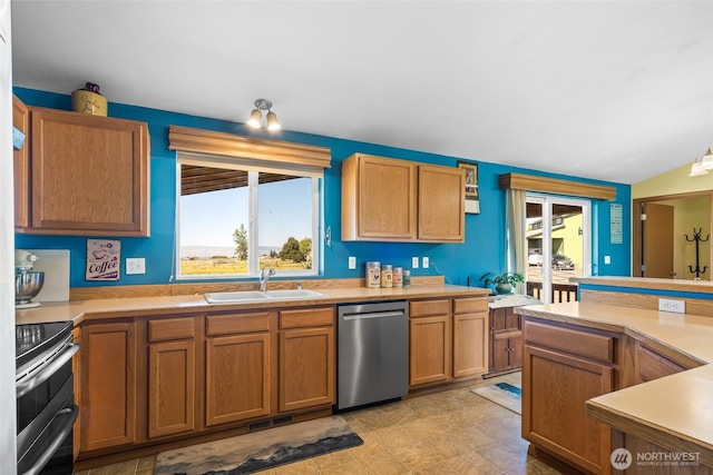 kitchen featuring plenty of natural light, appliances with stainless steel finishes, light countertops, and a sink