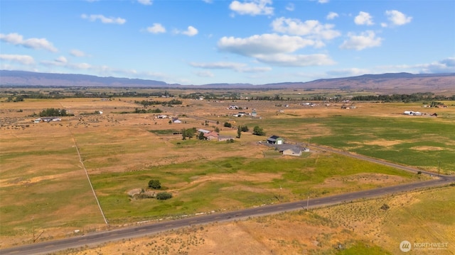 birds eye view of property with a mountain view and a rural view