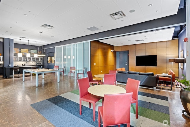 interior space featuring a paneled ceiling and visible vents