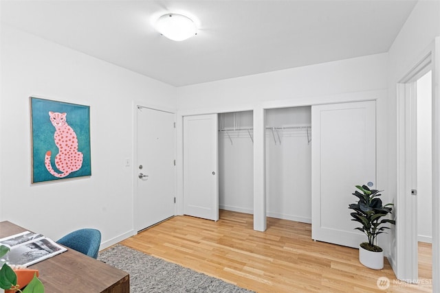 office space with light wood-style floors and baseboards