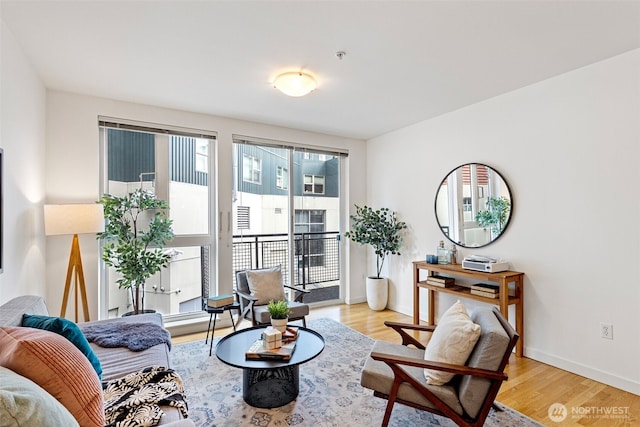 living area with light wood-style flooring and baseboards