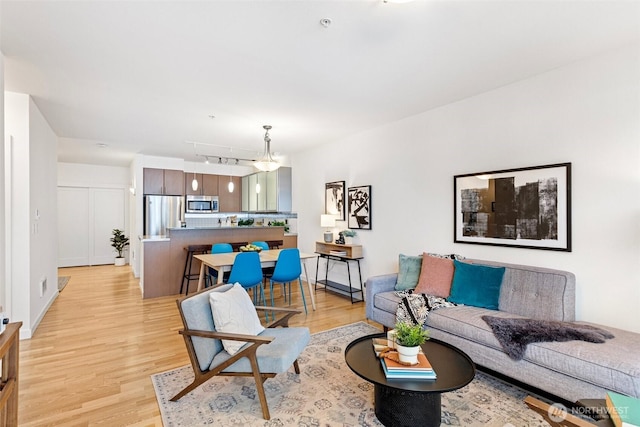 living room featuring light wood-style floors and track lighting