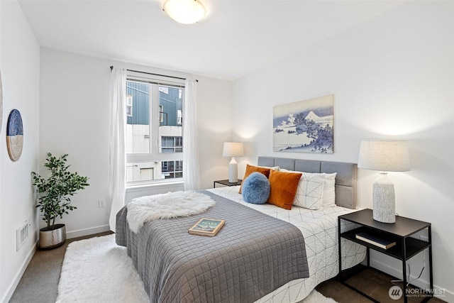 carpeted bedroom featuring visible vents and baseboards