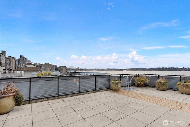 view of patio featuring a balcony and a city view