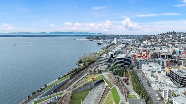 birds eye view of property featuring a water view and a view of city