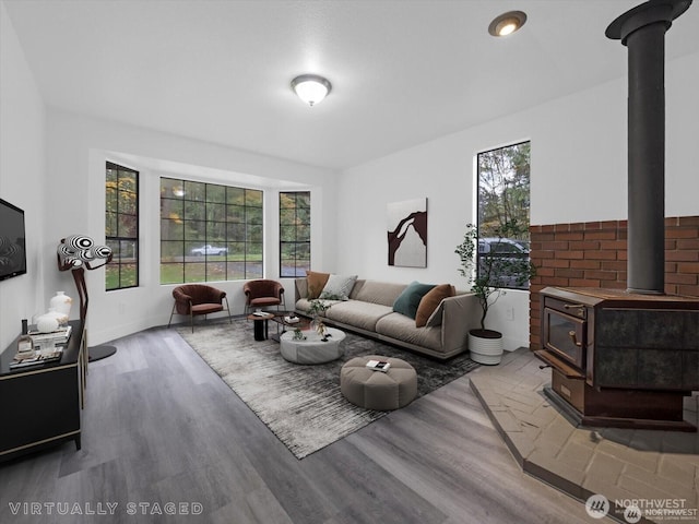 living room featuring a wood stove and hardwood / wood-style floors