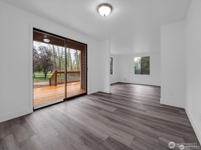 unfurnished room featuring dark wood-type flooring