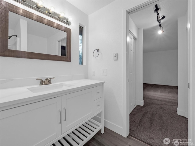 bathroom with track lighting and vanity