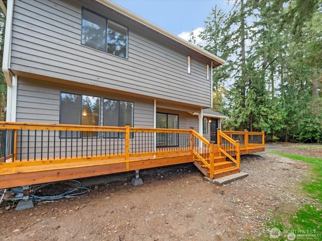 back of house with a wooden deck