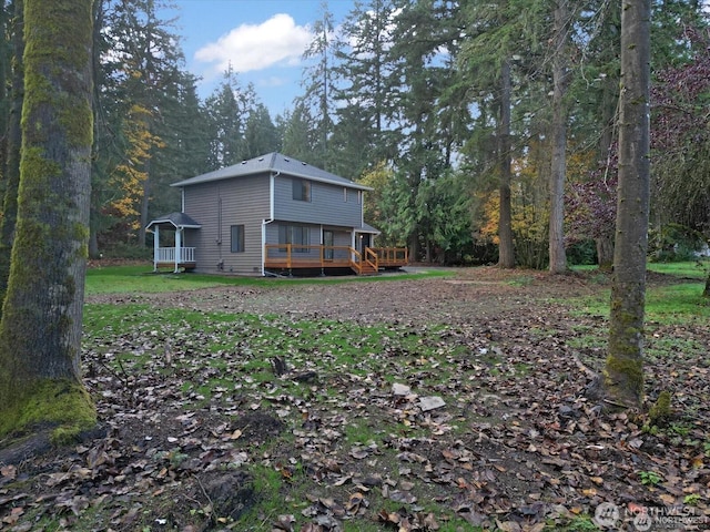 back of house featuring a wooden deck