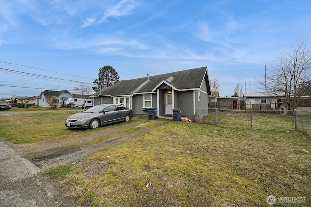 bungalow-style house featuring fence and a front lawn