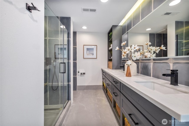 bathroom featuring vanity and an enclosed shower