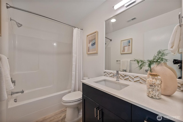 full bathroom featuring vanity, hardwood / wood-style floors, shower / bath combination with curtain, and toilet