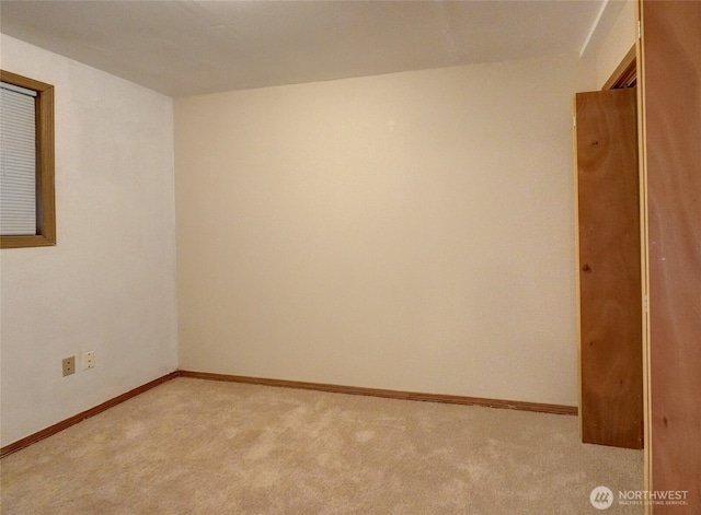 spare room with light colored carpet