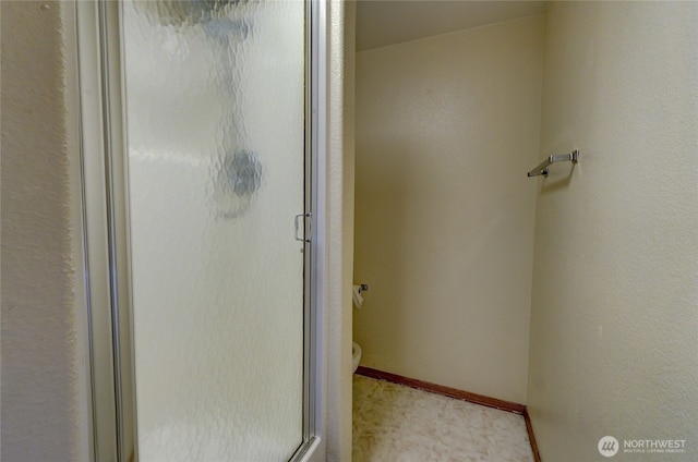 bathroom featuring a shower with door