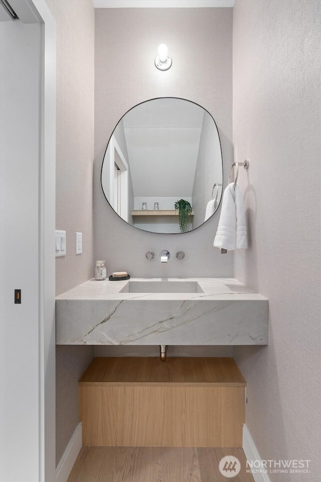 bathroom with baseboards and vanity