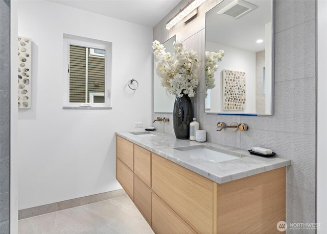 bathroom featuring tile patterned floors, vanity, and decorative backsplash