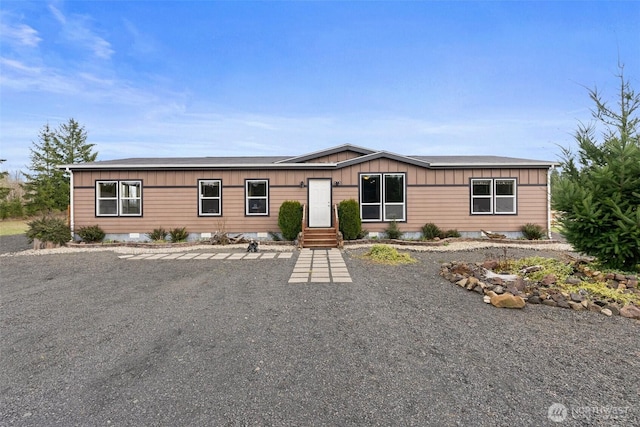 manufactured / mobile home with board and batten siding and entry steps