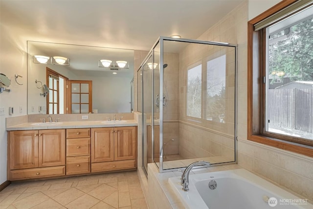 bathroom with independent shower and bath, vanity, and tile patterned floors