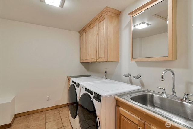 washroom featuring sink, light tile patterned floors, cabinets, and washer and dryer