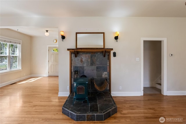 205 S Division, Cashmere, WA 98815 - living room featuring light wood-type flooring, baseboards, a wood stove, and stairway
