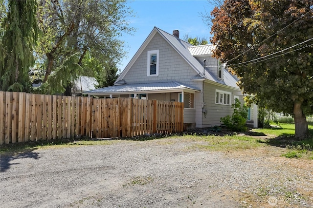 205 S Division, Cashmere, WA 98815 - view of side of home featuring metal roof, a chimney, and a standing seam roof