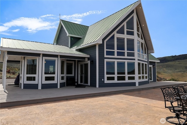 back of house with a standing seam roof and metal roof