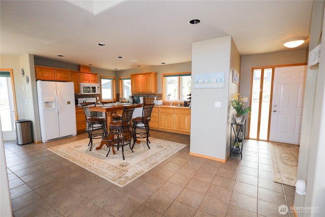 dining area featuring light tile patterned floors and baseboards