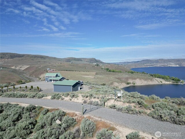 bird's eye view with a water and mountain view