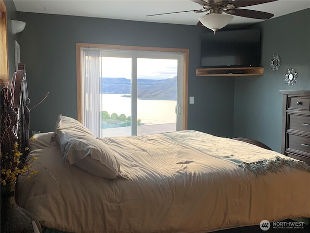 bedroom with access to outside and a ceiling fan