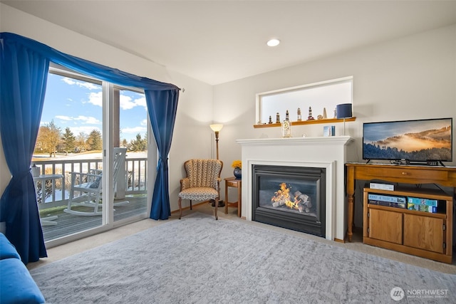 living room with a water view and light carpet