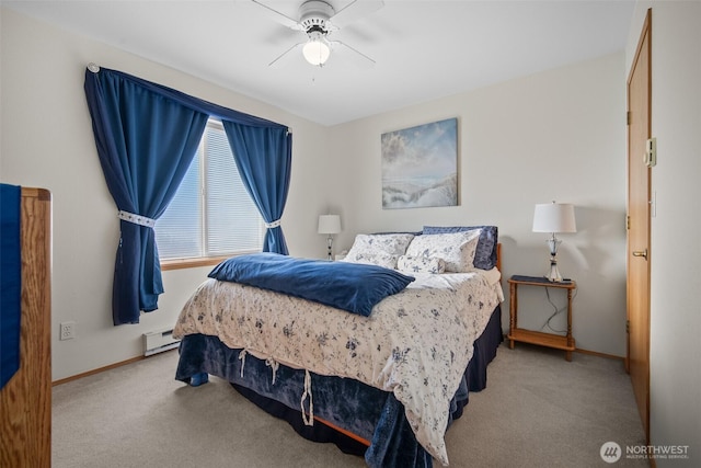 carpeted bedroom with a baseboard heating unit and ceiling fan