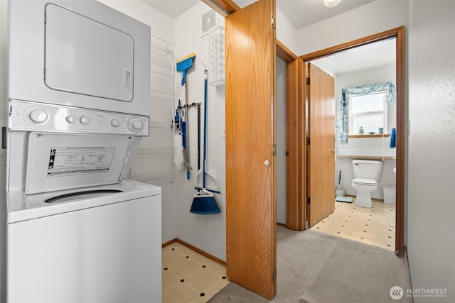 washroom featuring stacked washer / dryer